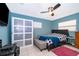 Bedroom with a modern ceiling fan, closet with sliding doors, and queen sized bed with a dark headboard at 1007 Maya Ave, Orlando, FL 32822