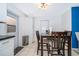Bright dining area featuring a dark wood table set, white walls and cabinetry, and tile flooring at 1007 Maya Ave, Orlando, FL 32822