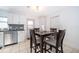 Dining area featuring a dark wooden table and access to the kitchen and backyard at 1007 Maya Ave, Orlando, FL 32822