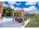 Outdoor patio with poolside gazebo and furniture, perfect for relaxation and entertaining guests at 1007 Maya Ave, Orlando, FL 32822