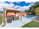 Outdoor patio with poolside gazebo, lounge chairs, and pool with tropical landscaping at 1007 Maya Ave, Orlando, FL 32822