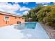 Backyard swimming pool with outdoor dining and lounge areas, ideal for summer enjoyment and entertaining at 1007 Maya Ave, Orlando, FL 32822