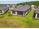 Aerial view of backyard featuring a screened lanai, a well-maintained lawn, and garden at 1014 Umbria Dr, Kissimmee, FL 34759