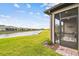 View of the home's screened-in lanai and peaceful water view, accessible from the brick-lined patio at 1014 Umbria Dr, Kissimmee, FL 34759
