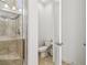Clean bathroom featuring a tiled shower with glass door and a separate toilet area, with white walls at 1014 Umbria Dr, Kissimmee, FL 34759