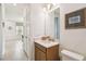 Bathroom featuring a vanity with a marble countertop and a view into the entryway and hallway at 1014 Umbria Dr, Kissimmee, FL 34759