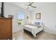 Bright bedroom with a ceiling fan, window, and a comfortable bed with neutral decor at 1014 Umbria Dr, Kissimmee, FL 34759