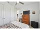 Bedroom with ceiling fan, large window, and dresser with television at 1014 Umbria Dr, Kissimmee, FL 34759
