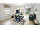 Bright and airy dining room features large windows, stylish chandelier, adjacent to a comfortable seating area at 1014 Umbria Dr, Kissimmee, FL 34759