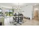 Dining room features a stylish chandelier, adjacent to a comfortable seating area with lovely water views at 1014 Umbria Dr, Kissimmee, FL 34759