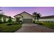 Charming single-story home featuring a two-car garage and well-manicured lawn at 1014 Umbria Dr, Kissimmee, FL 34759