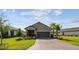 Charming front exterior view of home with well-maintained lawn and colorful landscaping at 1014 Umbria Dr, Kissimmee, FL 34759