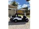 Pristine white golf cart featuring seating for four, providing both comfort and convenience for leisurely rides around the neighborhood at 1014 Umbria Dr, Kissimmee, FL 34759