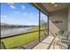 Relaxing screened lanai with chairs and a view of the water and lush landscaping at 1014 Umbria Dr, Kissimmee, FL 34759