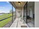 Screened-in lanai featuring a ceiling fan and views of the lawn and waterway at 1014 Umbria Dr, Kissimmee, FL 34759