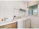 Bright laundry room featuring a sink, washer, dryer, and window with natural light at 1014 Umbria Dr, Kissimmee, FL 34759