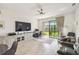 Open-concept living space offering sliding glass doors to patio and water views, office space, and neutral flooring at 1014 Umbria Dr, Kissimmee, FL 34759