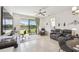 Living room with patio doors leading to water views, ceiling fan, and an adjacent home office area at 1014 Umbria Dr, Kissimmee, FL 34759