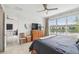Relaxing main bedroom boasts a scenic lake view from a large window, complemented by a ceiling fan and serene décor at 1014 Umbria Dr, Kissimmee, FL 34759