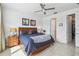 Comfortable main bedroom featuring a calming lake view, ceiling fan, and convenient access to the closet and ensuite bathroom at 1014 Umbria Dr, Kissimmee, FL 34759