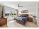 Tranquil main bedroom featuring a serene lake view from a large window, complemented by a ceiling fan and neutral décor at 1014 Umbria Dr, Kissimmee, FL 34759
