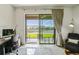 Water views from the screened-in patio door with outdoor seating and a comfortable home office area at 1014 Umbria Dr, Kissimmee, FL 34759