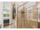 Ensuite bathroom showcasing a tiled walk-in shower, seamlessly connected to the main bedroom with serene lake views at 1014 Umbria Dr, Kissimmee, FL 34759