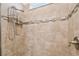 Detailed view of tiled shower walls with decorative accents, shower head, and a built-in niche for toiletries at 1014 Umbria Dr, Kissimmee, FL 34759