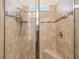 Modern shower featuring a frameless glass door, bench seating, and tiled walls with decorative accents at 1014 Umbria Dr, Kissimmee, FL 34759