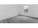 Bedroom with gray carpeting and white walls with a single window at 1019 Cloud Ridge Ct, Mount Dora, FL 32757