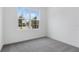 Bedroom with neutral carpet, white walls, and a large window at 1019 Cloud Ridge Ct, Mount Dora, FL 32757
