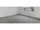 The new carpeted bedroom featuring natural light from two windows at 1019 Cloud Ridge Ct, Mount Dora, FL 32757