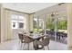 Bright dining area with sliding glass doors, a view of the backyard, and a modern dining set at 1019 Cloud Ridge Ct, Mount Dora, FL 32757