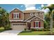 Charming two-story home with craftsman-style architecture, attached garage, and beautifully manicured lawn at 1019 Cloud Ridge Ct, Mount Dora, FL 32757