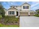 Home exterior boasts a 3-car garage, stone accents, and a well-manicured lawn at 1019 Cloud Ridge Ct, Mount Dora, FL 32757