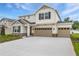 Exterior of a home with a 3-car garage, stone accents, and craftsman-style details at 1019 Cloud Ridge Ct, Mount Dora, FL 32757
