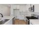 Kitchen with white cabinets, stainless steel appliances, and a center island with sink at 1019 Cloud Ridge Ct, Mount Dora, FL 32757