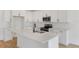 Bright kitchen featuring white cabinets, stainless steel appliances, and a center island with sink at 1019 Cloud Ridge Ct, Mount Dora, FL 32757