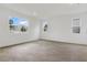 Bright living room featuring wood-look tile flooring and large windows at 1019 Cloud Ridge Ct, Mount Dora, FL 32757