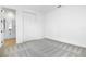 Clean bedroom featuring a carpeted floor, white walls, double door closet, and an ensuite bathroom at 1067 Cloud Ridge Ct, Mount Dora, FL 32757