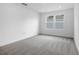 A well-lit bedroom with neutral carpet and a window offering natural light at 1067 Cloud Ridge Ct, Mount Dora, FL 32757