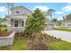 Well manicured front lawn showing stone retaining wall, shrubbery, trees, and part of a charming home at 1067 Cloud Ridge Ct, Mount Dora, FL 32757