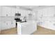 Bright kitchen featuring white cabinets, subway tile backsplash, stainless appliances, and a large center island at 1067 Cloud Ridge Ct, Mount Dora, FL 32757