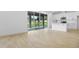 Open-concept living area featuring wood-look tile flooring, bar seating, and sliding glass doors to the backyard at 1067 Cloud Ridge Ct, Mount Dora, FL 32757
