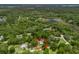 Aerial view showing property with tree coverage and nearby waterway, highlighting property's location and surroundings at 1081 Se 174Th Ter, Silver Springs, FL 34488