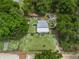 Aerial view showcasing the property's location with the house, swimming pool, shed, and surrounding foliage at 1081 Se 174Th Ter, Silver Springs, FL 34488
