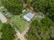 Birds eye view featuring the house, greenhouse, pool and sprawling greenery of the property at 1081 Se 174Th Ter, Silver Springs, FL 34488