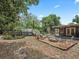 Expansive backyard featuring a screened-in porch, deck, and fire pit area at 1081 Se 174Th Ter, Silver Springs, FL 34488