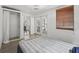 Bright bedroom featuring an inflatable bed, white walls, and doors leading to a porch at 1081 Se 174Th Ter, Silver Springs, FL 34488