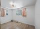 Bright bedroom with two windows, white walls, and wood laminate flooring at 1081 Se 174Th Ter, Silver Springs, FL 34488
